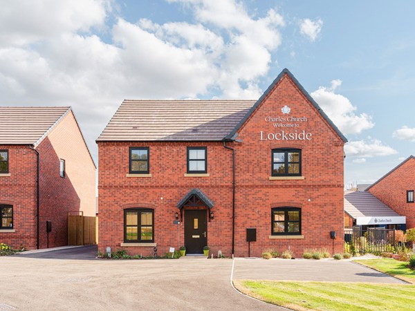 Exterior view of a modern red-brick home at Lockside development.