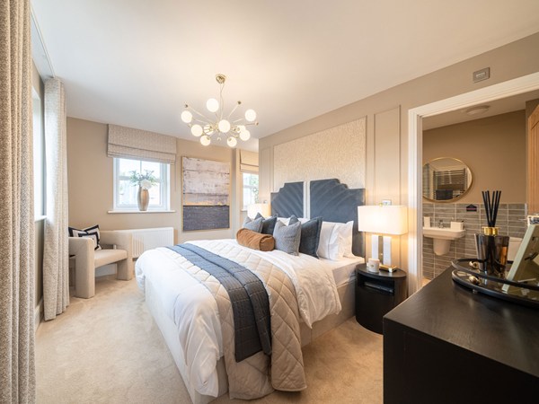 Main bedroom with double bed, seating area and en suite