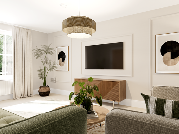 Bright living room with a green sofa, matching armchair, and a round wooden coffee table. A large flat-screen TV is mounted on the wall above a wooden media unit, flanked by abstract framed artwork. Light curtains frame the window, and potted plants add greenery.