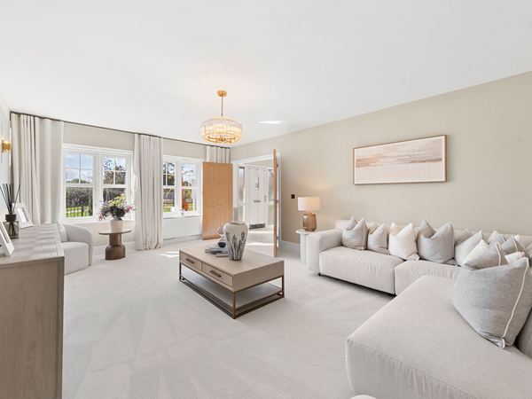Spacious living room with neutral furnishings and large windows