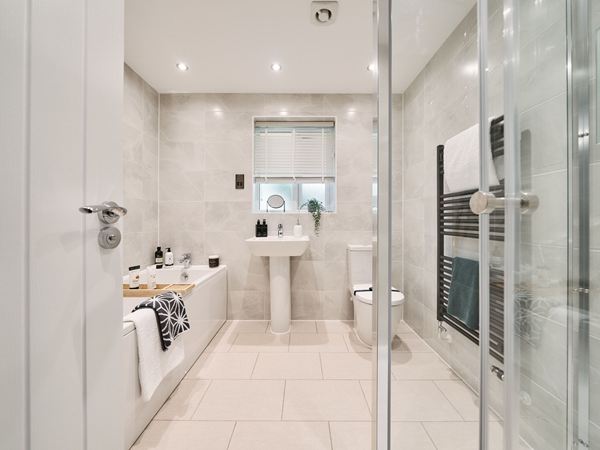 A bright and modern bathroom in a Charles Church home with marble effect tiles.