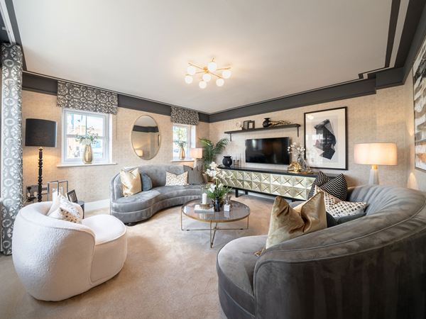 Show home living room with curved sofas and contemporary furnishings