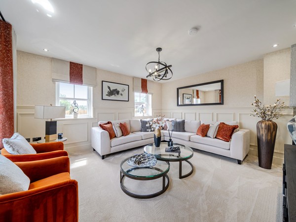 Spacious living room with corner sofa and orange armchairs