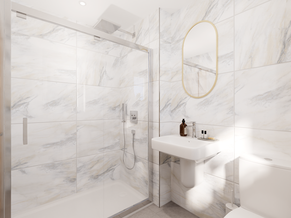 Modern en-suite bathroom with marble-effect wall tiles, a glass-enclosed shower, and a wall-mounted sink beneath an oval mirror. A white toilet is positioned on the right, and decorative items are placed on the sink.