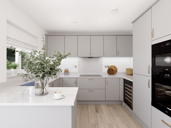 Contemporary kitchen with light gray cabinets, white countertops, and integrated appliances including an oven and wine cooler. A glass vase with greenery sits on the countertop, and natural light enters through a window above the sink. Wooden flooring adds warmth to the space.