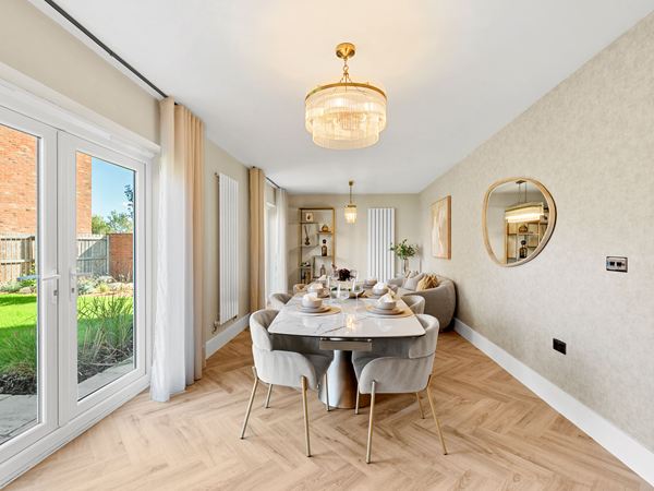 Spacious dining room with large table and doors to garden