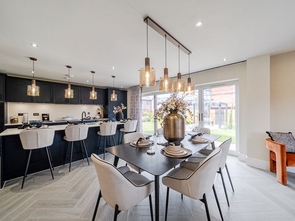 Open-plan kitchen and dining area with island and garden doors