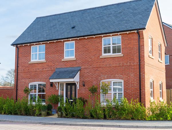 Front view of a detached red‑brick home at Ridge Walk with slate roof.