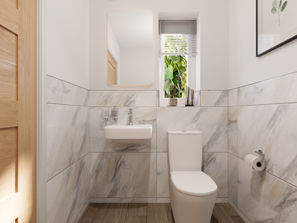 Compact bathroom with marble-effect wall tiles and wooden flooring. Features a white toilet and a small wall-mounted sink beneath a rectangular mirror. A narrow window with blinds and a potted plant adds greenery, and a toilet roll holder is mounted on the right wall.