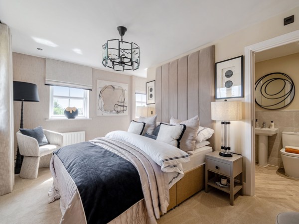 Double bedroom with upholstered headboard and adjoining en-suite bathroom