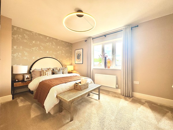 Double bedroom in the Brindle new build home with patterned feature wall.