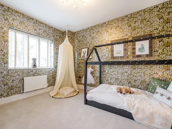 Child’s bedroom in a Charles Church show home at Festival Park with feature wallpaper.