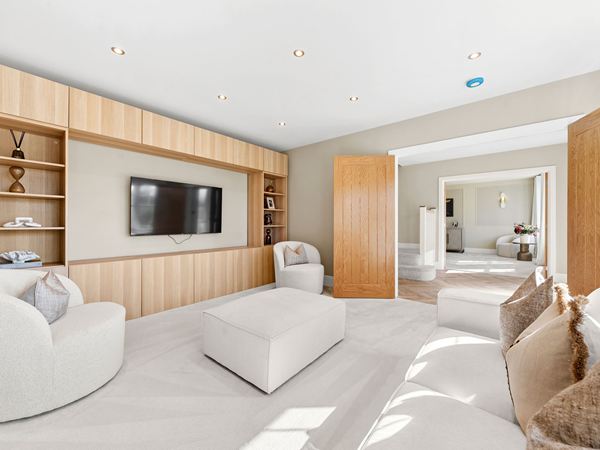 Modern living room with fitted media unit and neutral furnishings