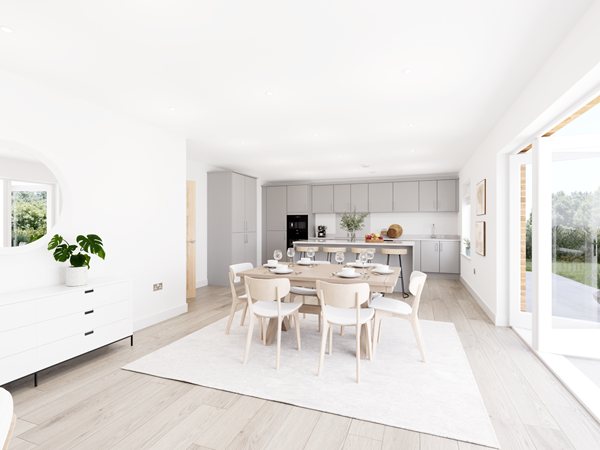 Modern kitchen with grey cabinets, white quartz worktops, built-in oven and island featuring fresh fruit and greenery