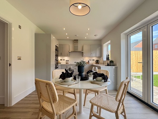Kitchen dining area with round table and garden doors