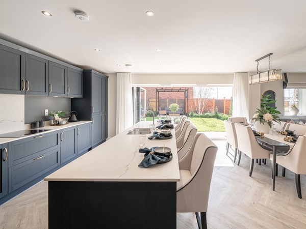 Open-plan kitchen dining area with island and garden views
