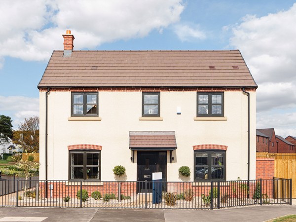 Front exterior of new build home with cream rendered finish