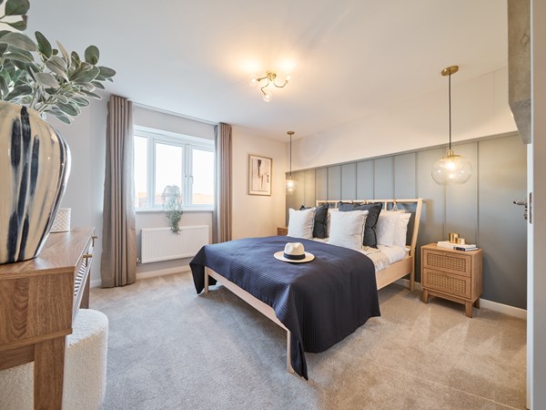Double bedroom with grey panelling behind bed