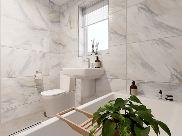 Modern bathroom with marble-effect wall tiles, a white toilet, and a wall-mounted sink beneath a small window with blinds. A bathtub with a wooden tray holding a green plant is in the foreground, and decorative items are placed on the bath edge.