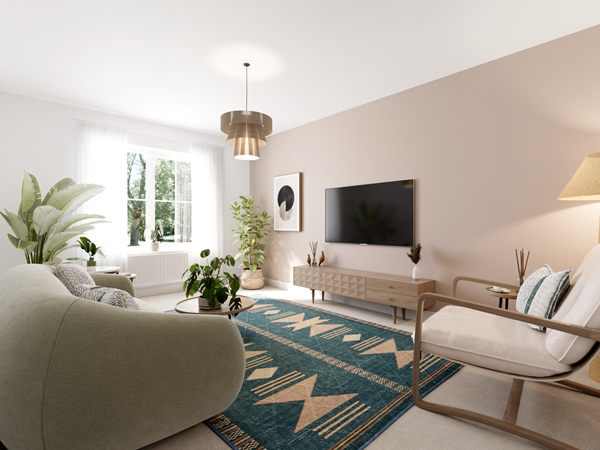 Bright living room with a curved sofa, a wooden armchair, and a round coffee table on a patterned teal rug. A large flat-screen TV is mounted on a beige feature wall above a wooden media unit. Potted plants add greenery, and natural light streams through a window with sheer curtains.