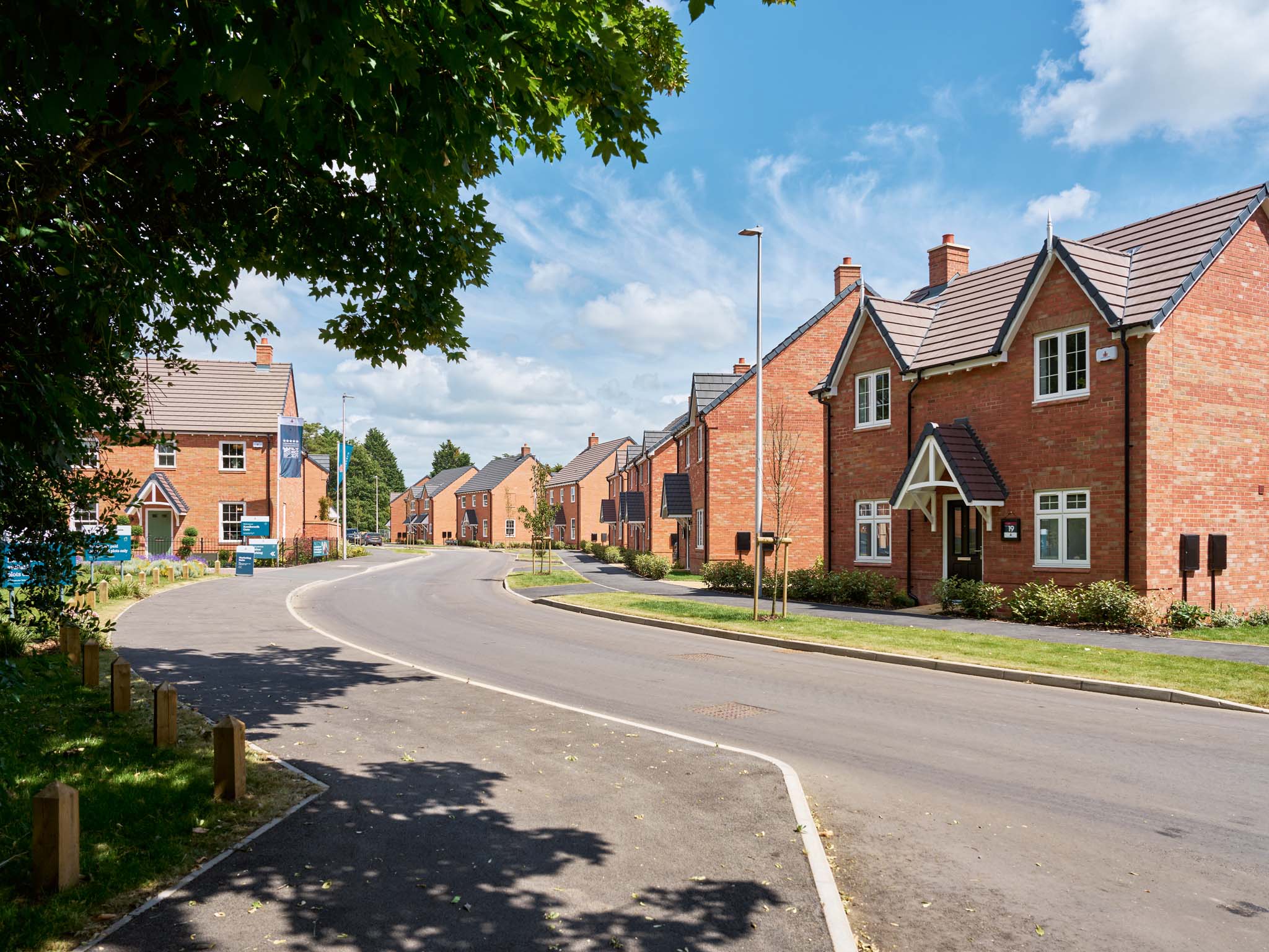 An exterior view of Charles Church premium new red brick homes at Kenilworth Gate.