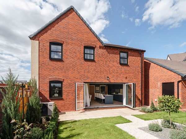 Rear view of new build home with garden and bi-fold doors