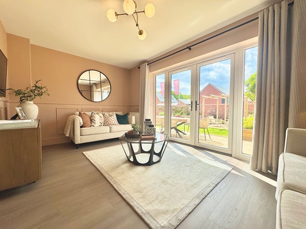 Living room in the Brindle new build home with French doors and neutral décor.