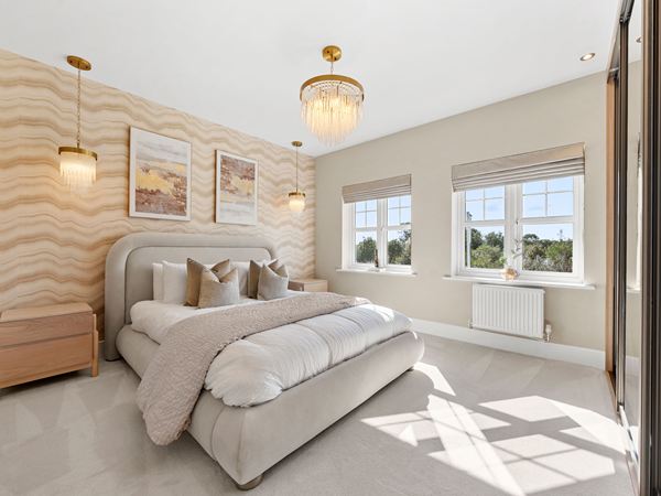 Spacious bedroom with upholstered bed, large windows and neutral décor