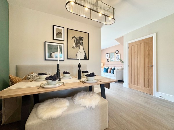 Dining area in the Brindle new build home with bench seating and open-plan layout.
