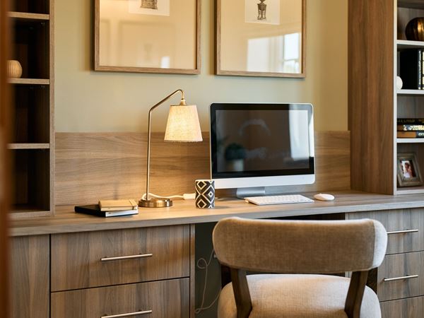 An office space in a modern Charles Church home with a built in desk and shelving. 
