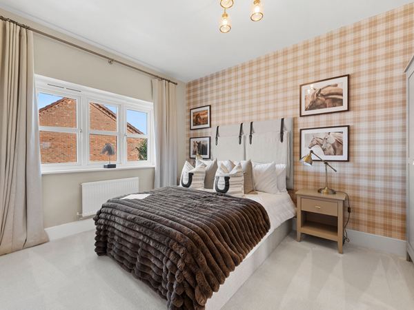 Modern bedroom with upholstered bed, patterned wall and neutral décor