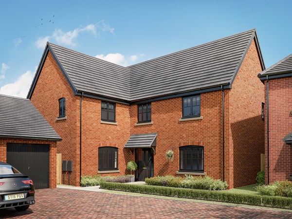 Modern red brick detached house with grey tiled roof, black windows and garage on a sunny day