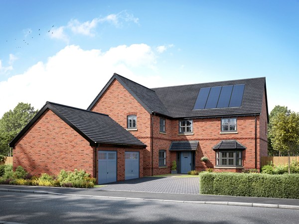 Modern red brick detached house with grey tiled roof, black windows and garage on a sunny day