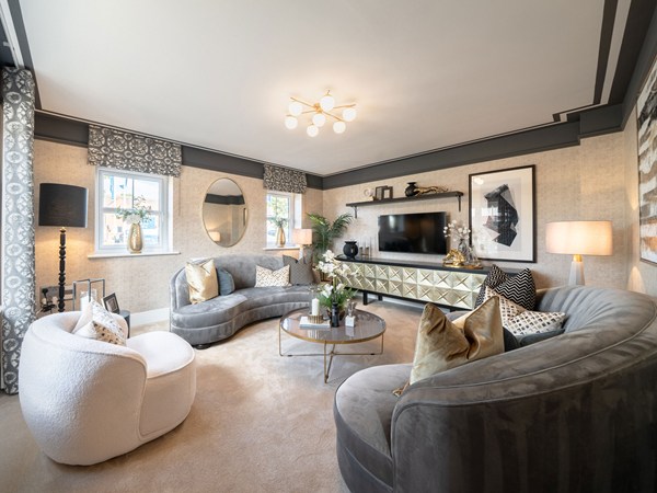 Living room with curved sofas, armchairs and contemporary neutral décor
