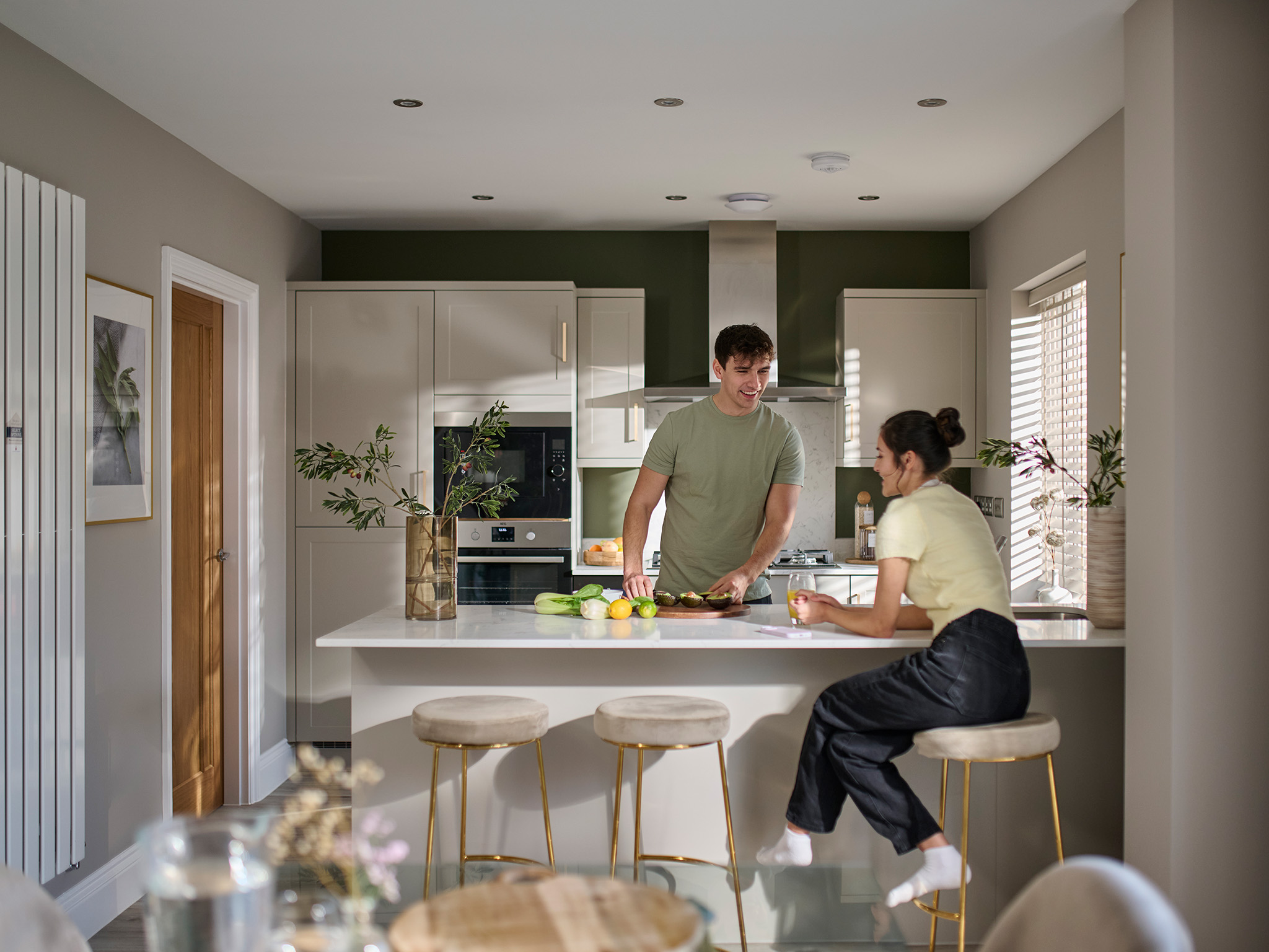 young couple laughing in a modern Charles Church kitchen