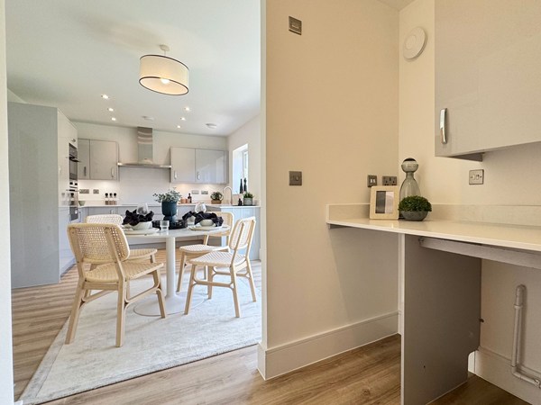 Utility area adjoining kitchen dining space with fitted worktop