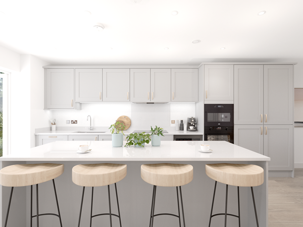 Modern kitchen with light gray cabinets, white countertops, and a large central island featuring four wooden bar stools. Integrated appliances, including an oven and coffee machine, are visible. Recessed ceiling lights and natural light from glass doors brighten the space.
