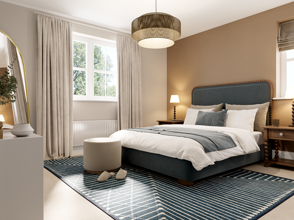 Elegant bedroom with a large upholstered bed in dark blue, dressed in white and gray bedding. A beige feature wall adds warmth, complemented by wooden bedside tables with lamps. A patterned blue rug covers the floor, and natural light streams through a window with light curtains.