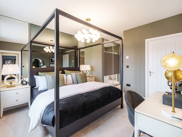 Main bedroom in a Charles Church show home at Festival Park with four-poster bed.