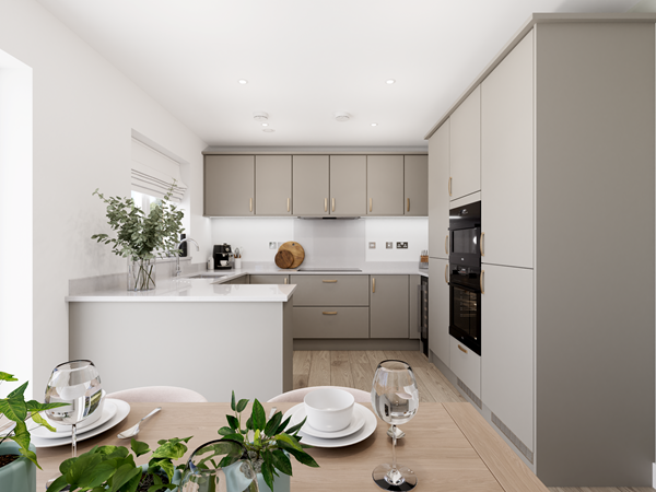 Contemporary kitchen with grey cabinets, integrated appliances and dining table set for two in bright open space.