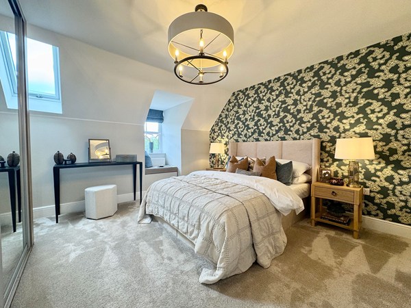 Main bedroom in the Brindle new build home with skylight and mirrored wardrobes.