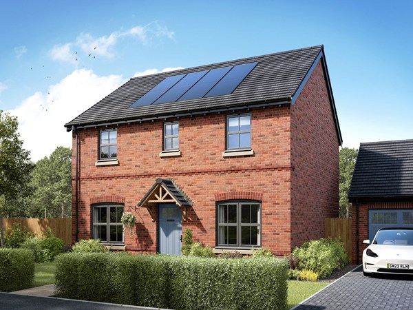 Two-story detached brick house with a gray tiled roof and solar panels. Features white-framed windows, a small porch with a gray front door, and a paved driveway on the left. Lavender plants line the front garden, and the house is set against a clear blue sky.