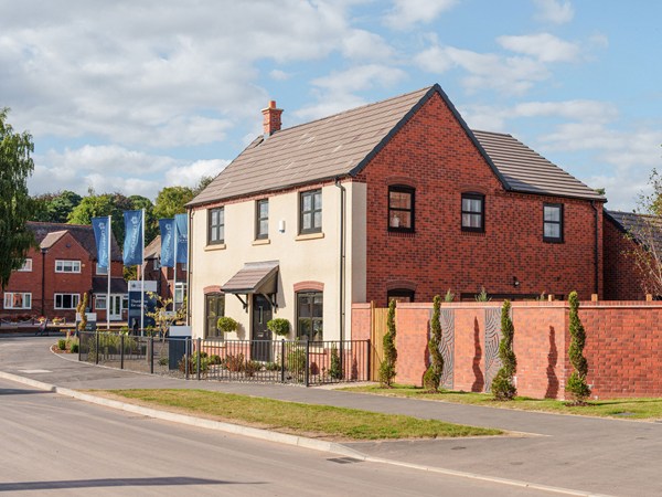 Exterior view of modern new build homes with landscaped frontage
