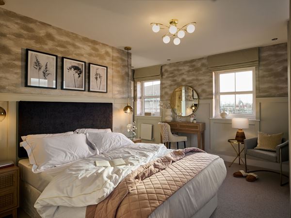 A beautiful modern bedroom in a Charles Church home, with a large double bed.