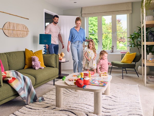 Family walking into a modern living room.