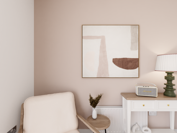 A close up shot of pale, neutral pink coloured living room with a retro radio and arm chair.