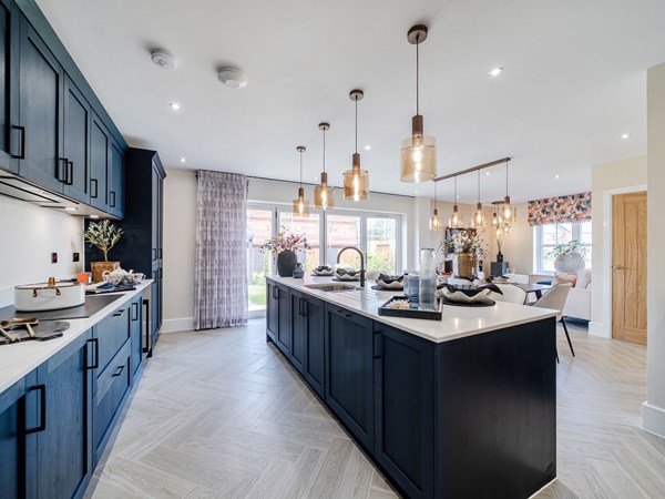 Contemporary kitchen with dark cabinetry and large central island