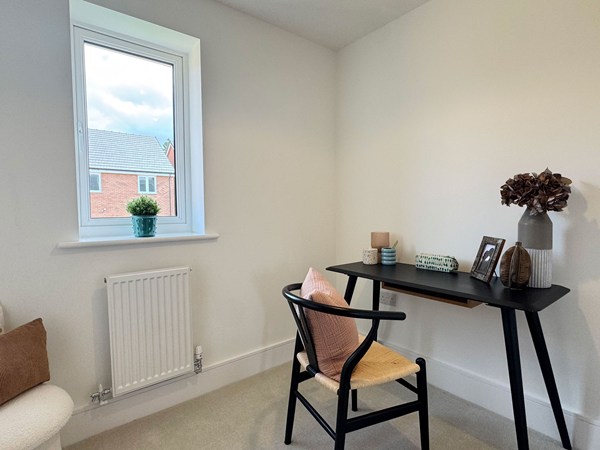 Study with desk, chair and window overlooking neighbouring homes