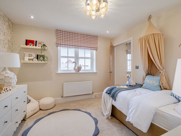 Children's bedroom with single bed, canopy and neutral décor